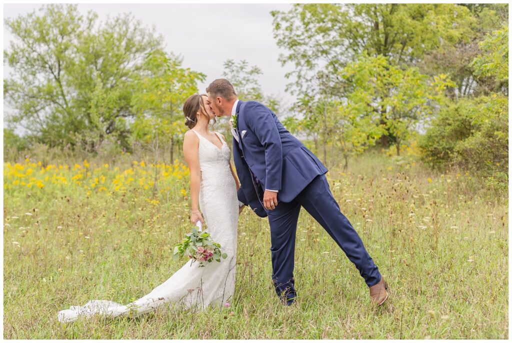 wedding couple share a kiss on their farm in Bowling Green, Ohio