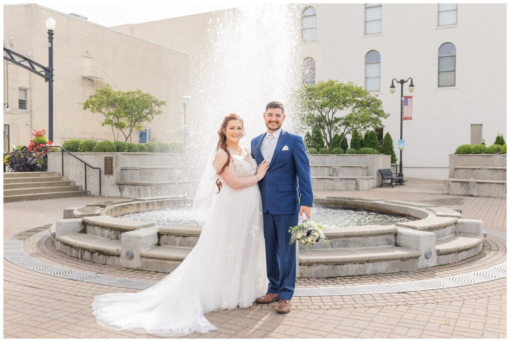 wedding couple posing in front of the fountain in downtown Sandusky, Ohio