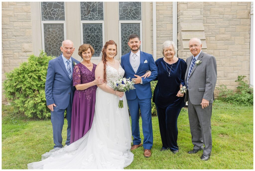 bride's grandparents posing with bride and groom outside church