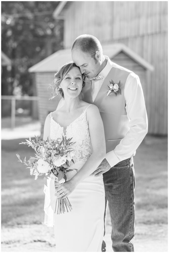 bride and groom portraits in front of a barn in northwest Ohio