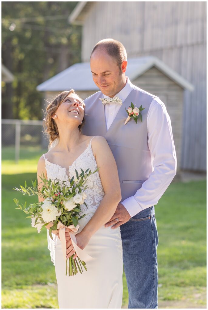 bride and groom posing near a barn in Norwalk, Ohio