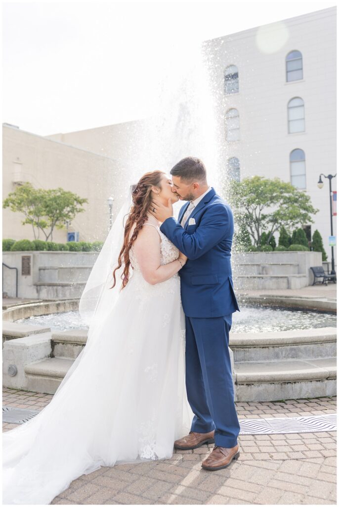 wedding couple kissing in front of the fountain in downtown Sandusky, Ohio