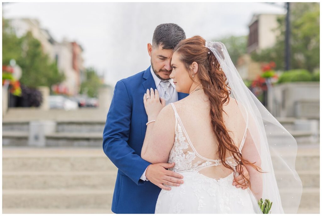 back of bride's dress while groom is holding her waist in Sandusky, Ohio