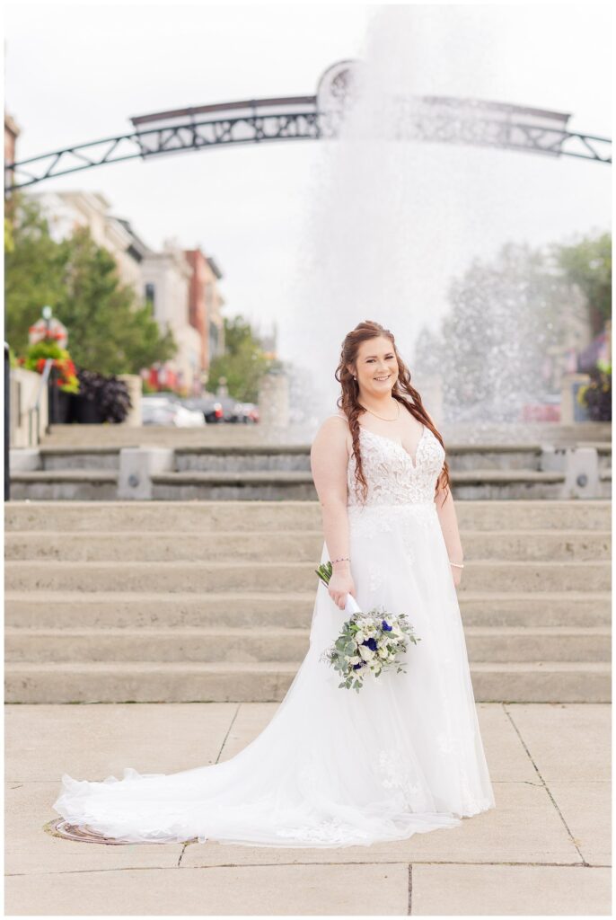 bride holding her bouquet and posing at the bottom of the stairs in downtown Sandusky