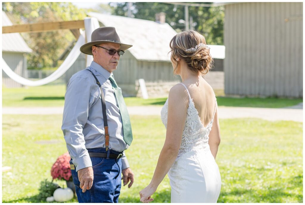 bride having a first look with her dad at the Huron County Fairgrounds
