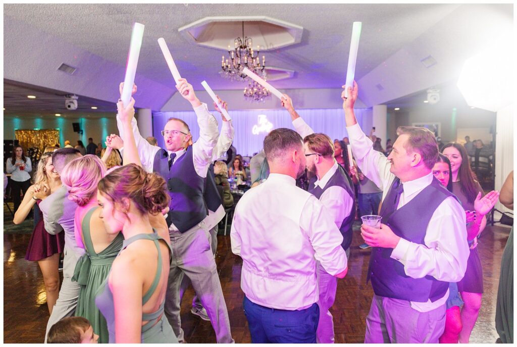 bridal party holding light sticks at wedding reception in northwest Ohio