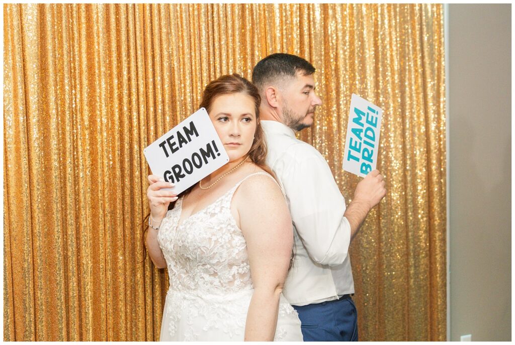 bride and groom holding signs at photo booth at Sandusky Ohio reception venue