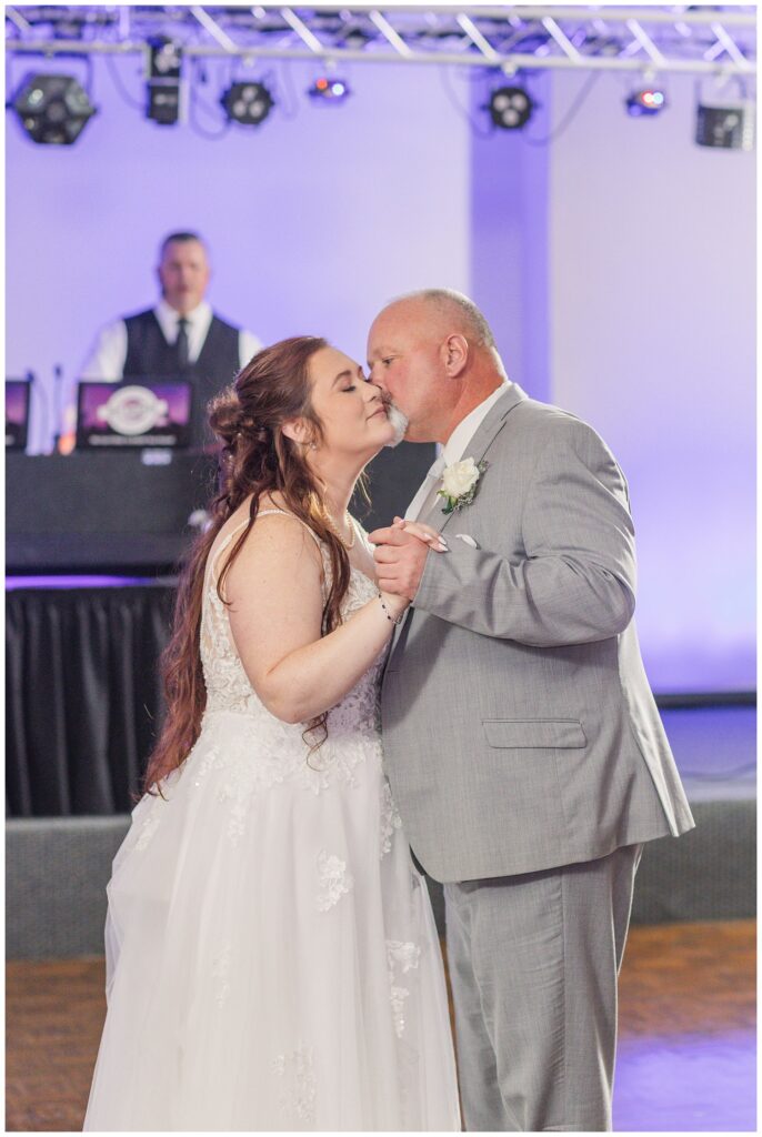 bride's dad gives her a kiss after their dance together at 1058 event center 