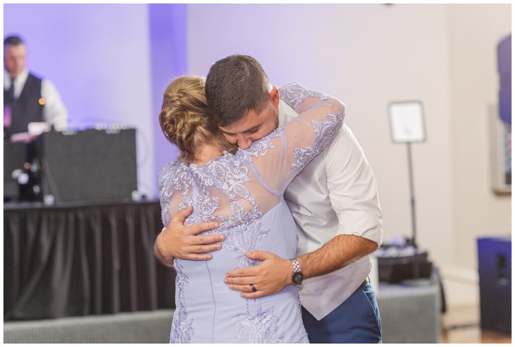 groom giving his mom a hug while dancing with her at Ohio reception venue