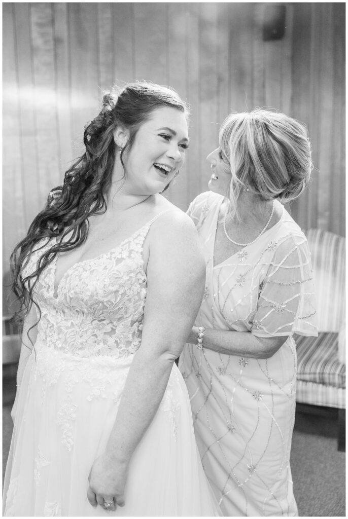 bride laughing with her mom while getting ready for wedding in Bellevue, Ohio