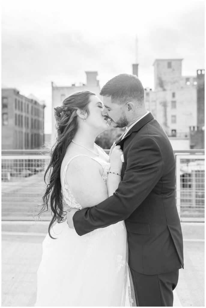 bride and groom share kiss along walking bridge in downtown Sandusky