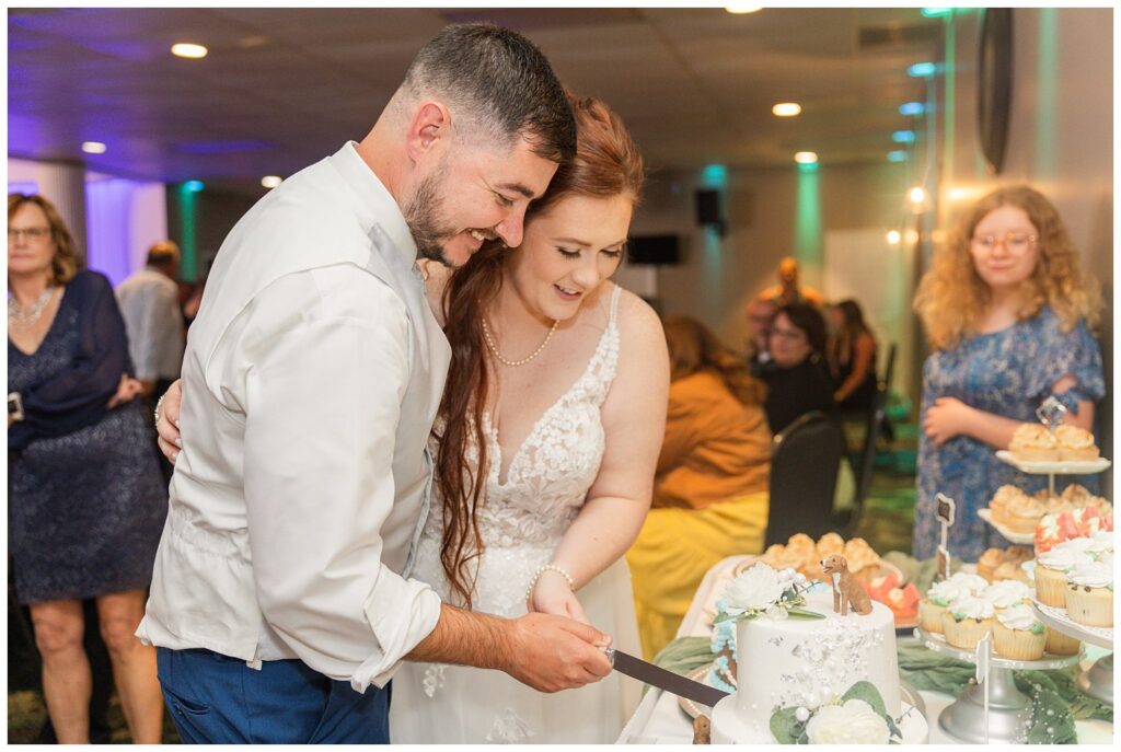 wedding couple cut cake together at reception in Sandusky, Ohio