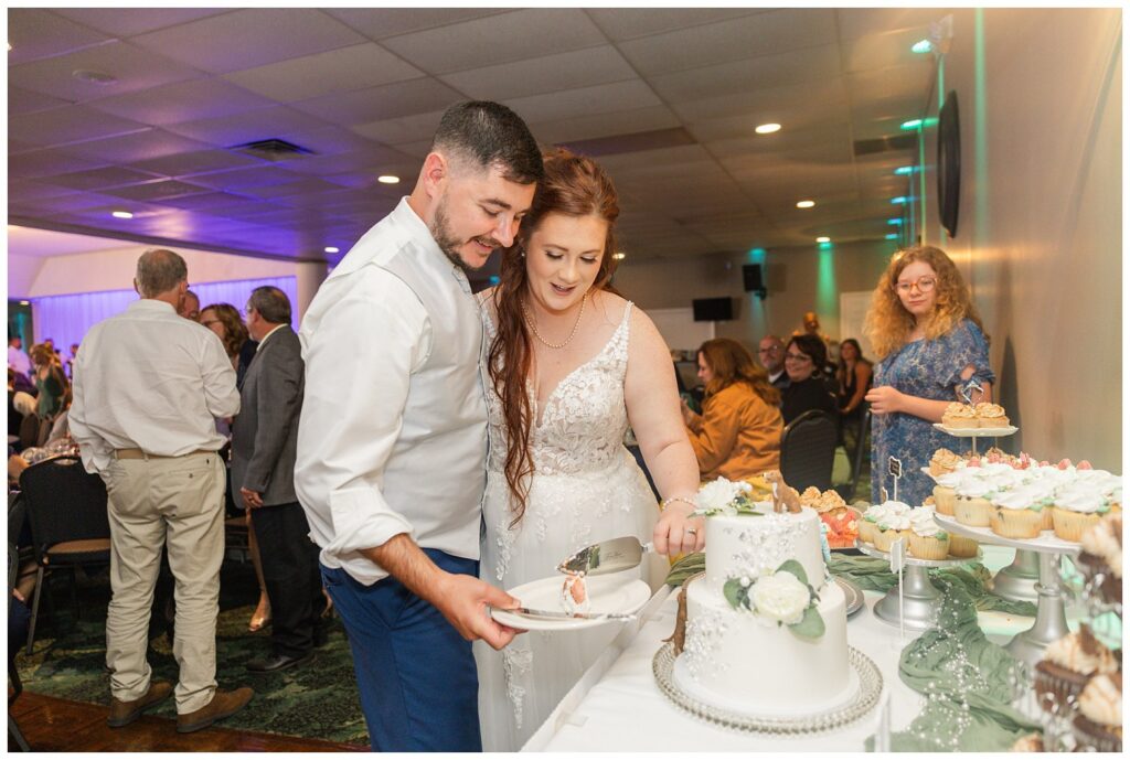 wedding couple cut cake together at reception in Sandusky, Ohio