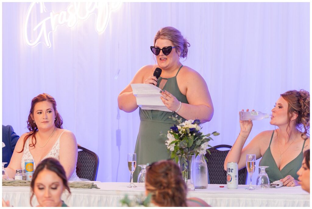 maid of honor giving toast while wearing sunglasses 