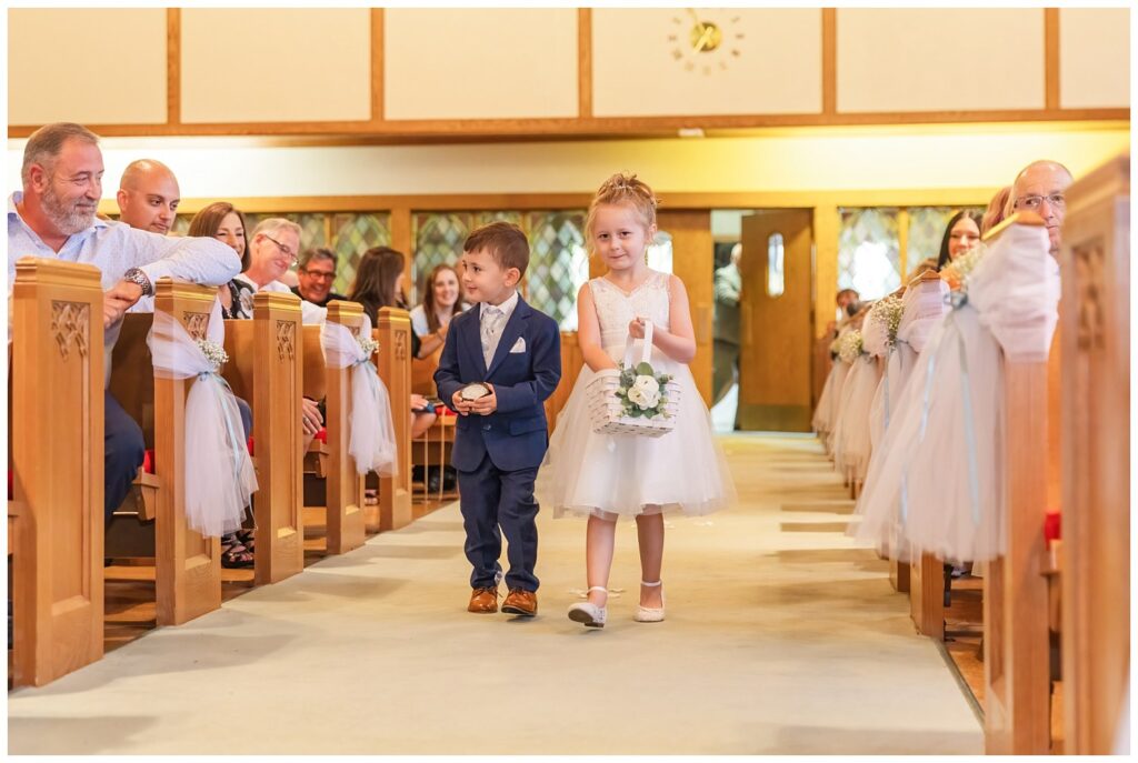 ring bearer and flower girl walking down the aisle at Lutheran wedding ceremony in Ohio
