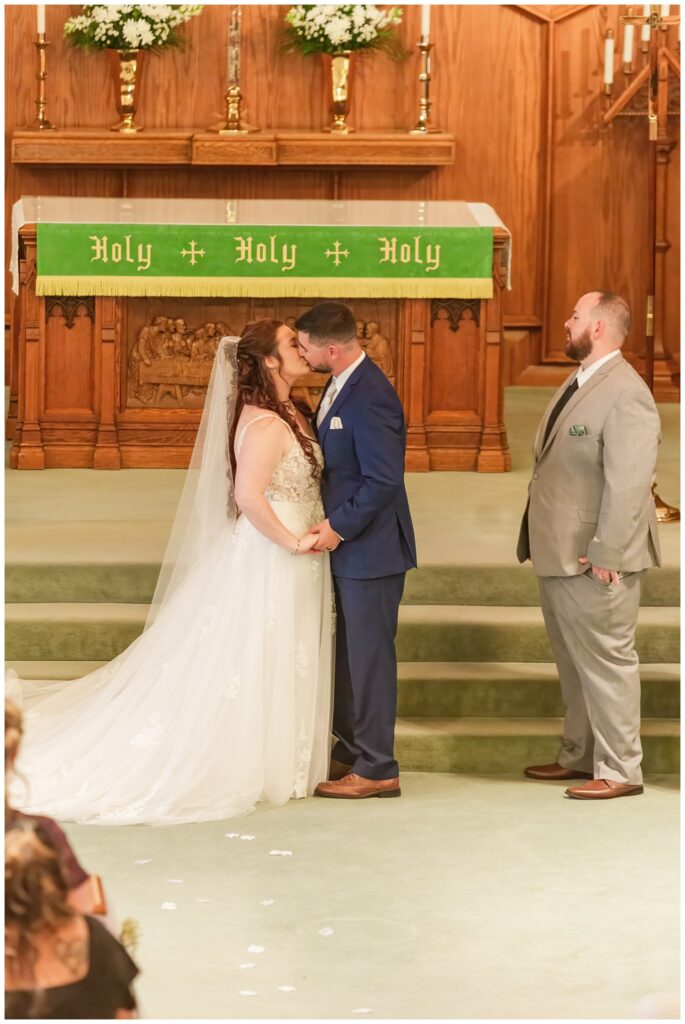 wedding couple share kiss at the end of the ceremony in northwest Ohio