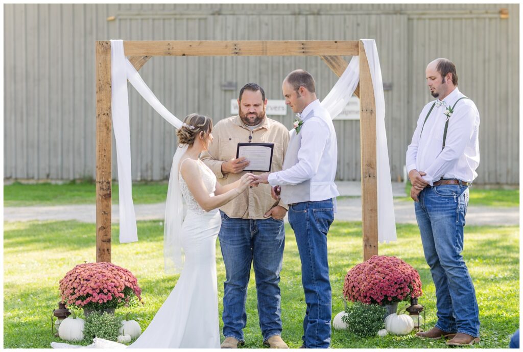wedding couple exchanging rings at fall ceremony in Norwalk, Ohio