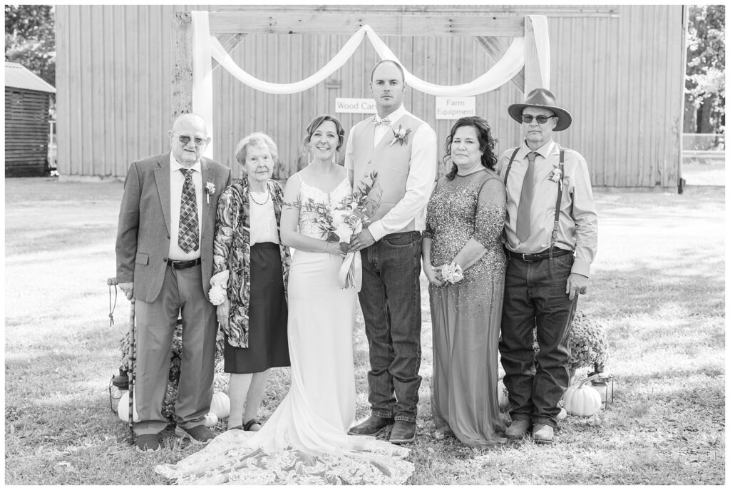 family formals in front of a wooden arch in Norwalk, Ohio