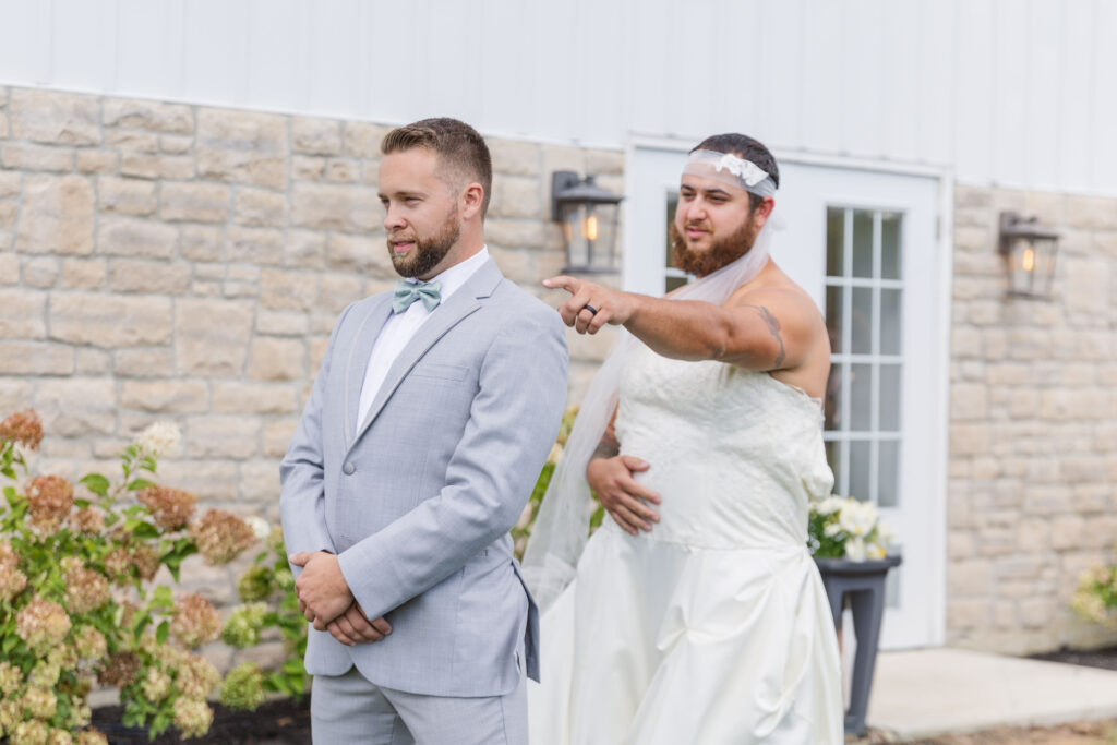 fake first look with the best man and groom outside 