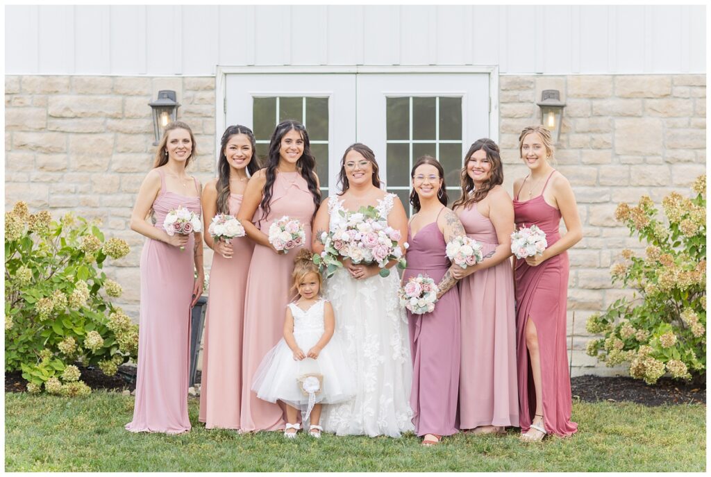 bridal party posing in front of wedding venue's white doors in Tiffin Ohio