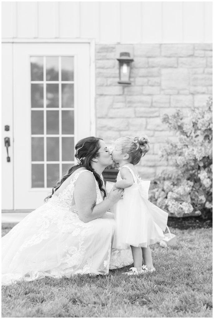 bride and her daughter share a sweet kiss before the ceremony at Arlington Acres