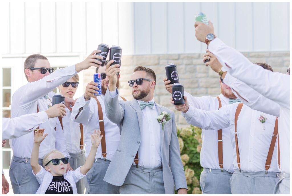 groomsmen toasting beers outside the wedding venue in northwest Ohio