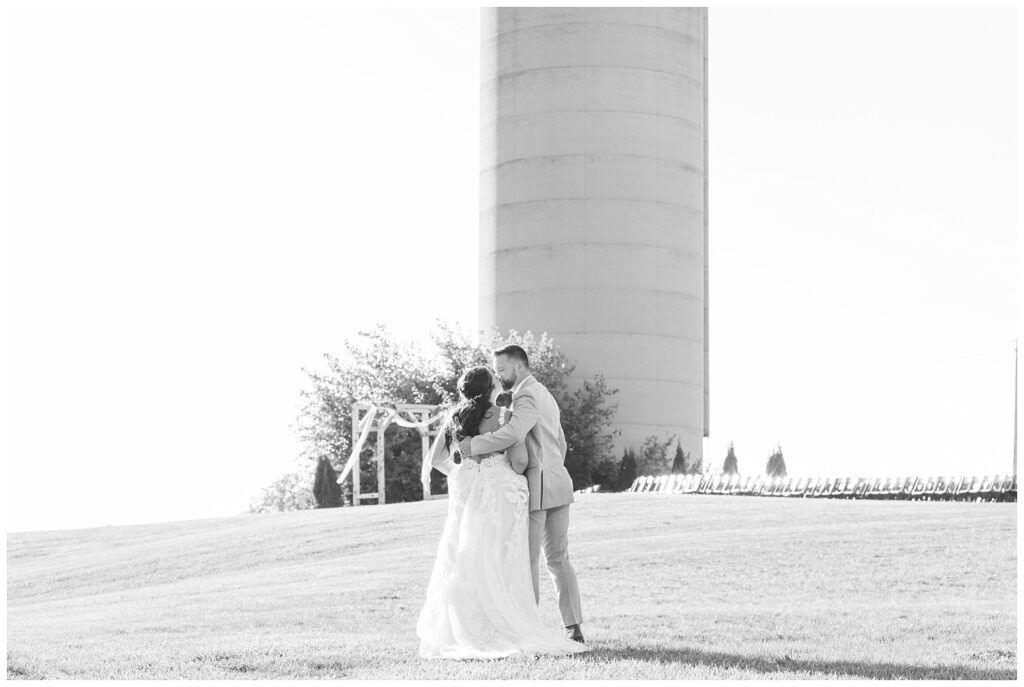 wedding couple kiss in front of a white silo at a barn venue in Tiffin Ohio