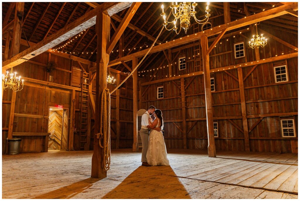 bride and groom share one last dance in barn at Arlington Acres