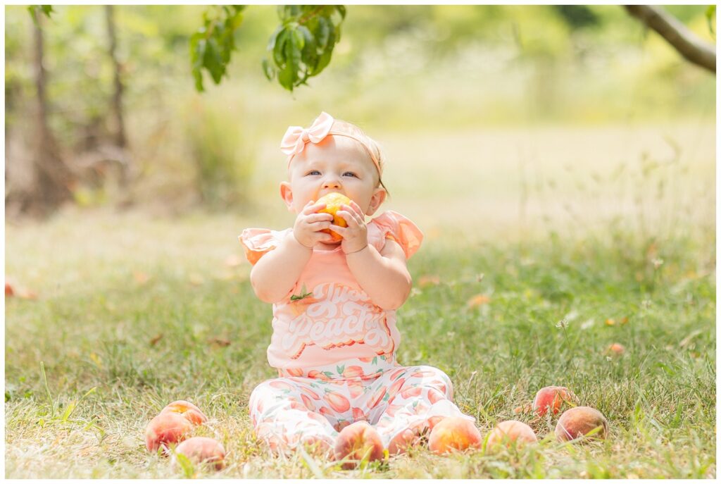 baby eating a peach outside in Fremont, Ohio milestone session