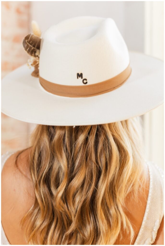 close up detail of the bride's ivory cowboy hat with her initials