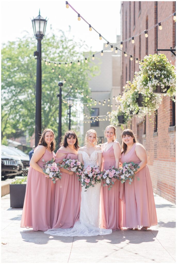 bride and her party posing on the sidewalk in downtown Tiffin, Ohio 