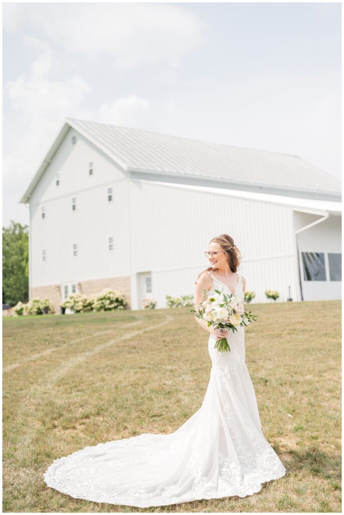 bride posing and holding her bouquet outside the Arlington Acres venue in Tiffin, Ohio