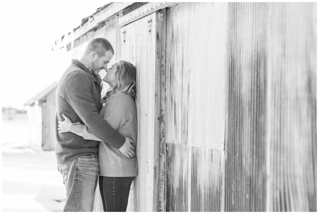 engagement session in front of a white barn in the snow in Fremont, Ohio