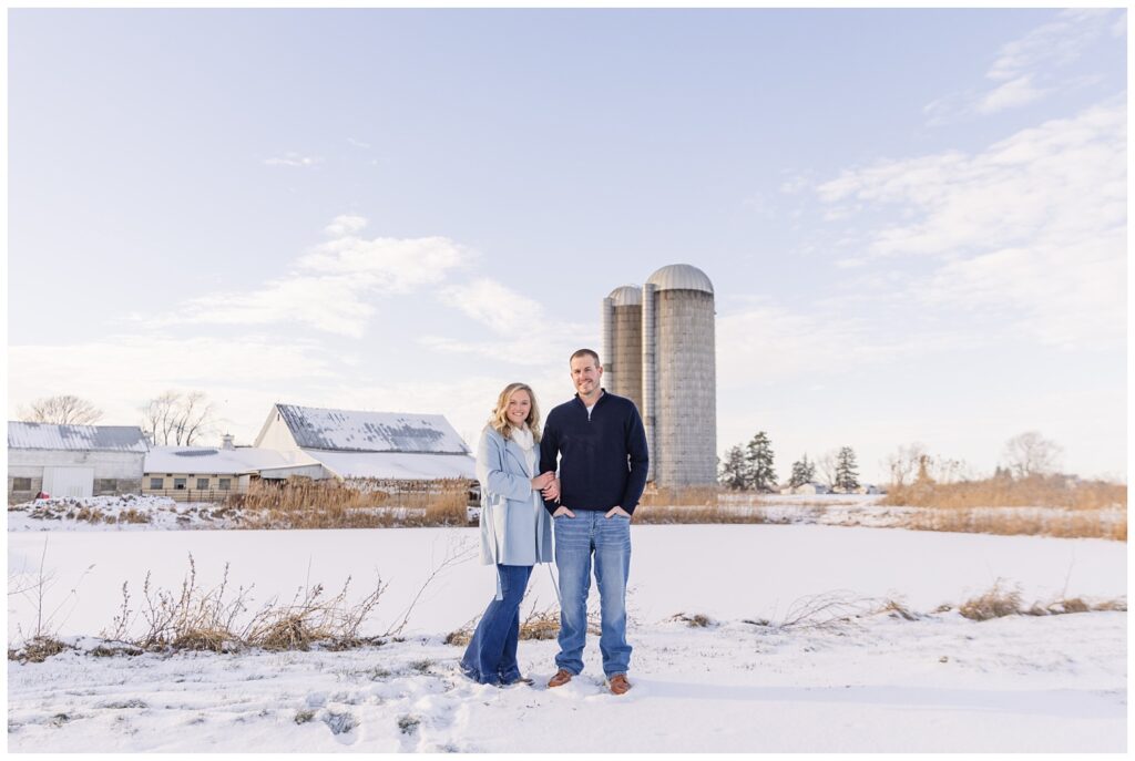 engaged couple posing in the snow at Jer and Bel Farms in Fremont, Ohio