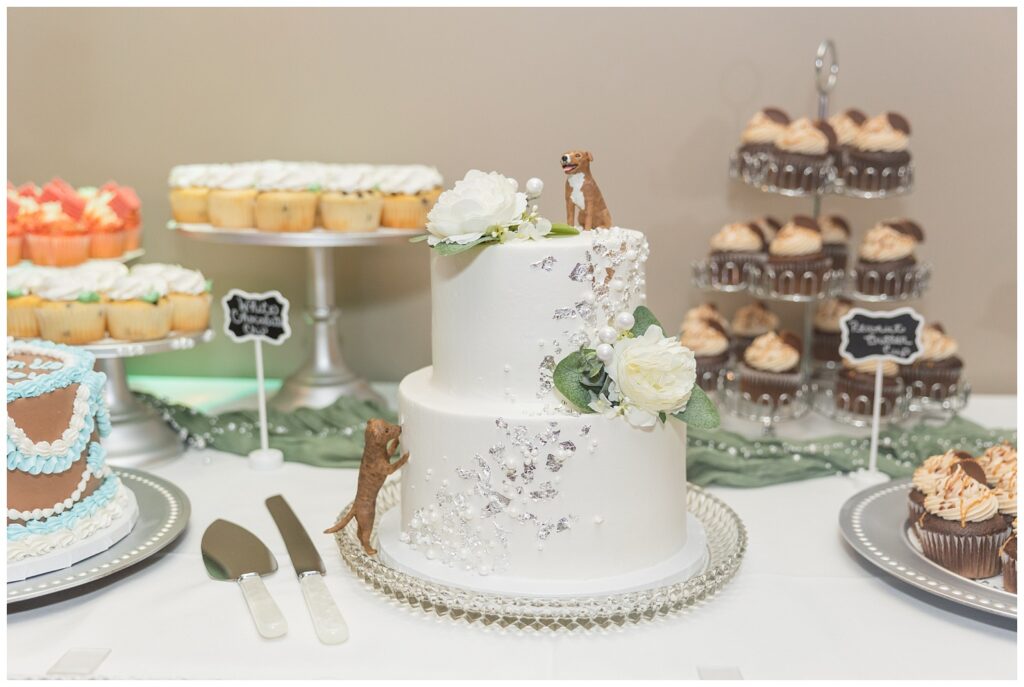 table of wedding cake with dog topper and other sweets in northwest Ohio