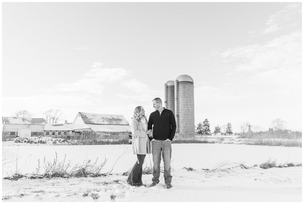 couple looking at each other standing in the snow on a farm in Ohio