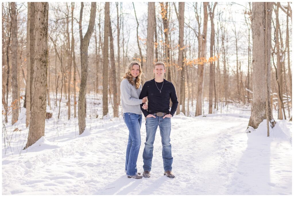 engaged couple posing in the snow for winter session in Columbus, Ohio