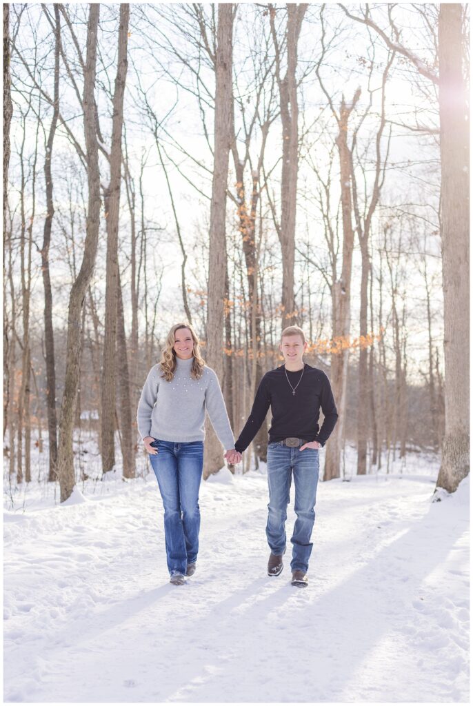 Columbus, Ohio engaged couple walking hand in hand in the snow