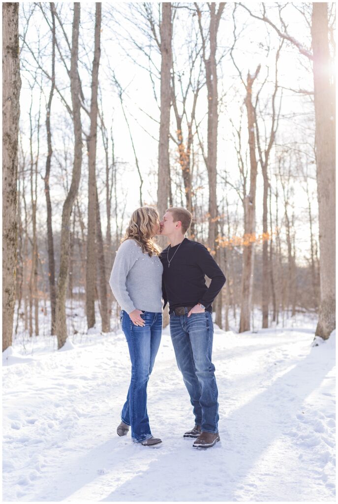 couple share a kiss at Highlands Metro Park winter engagement session