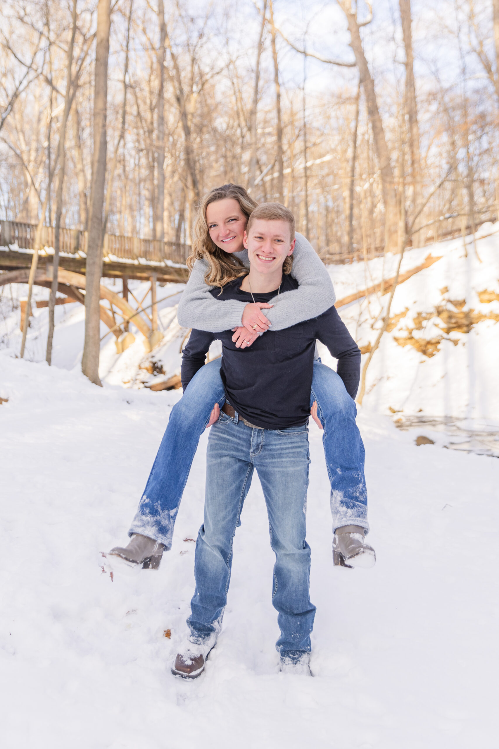 couple piggybacking in the snow at Highlands Metro Park
