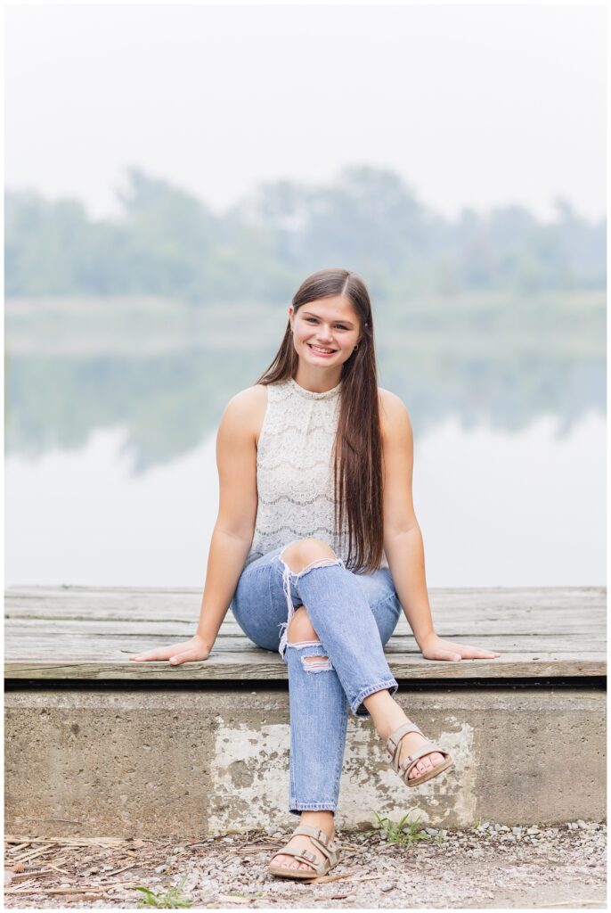 high school senior sitting on a dock in northwest Ohio