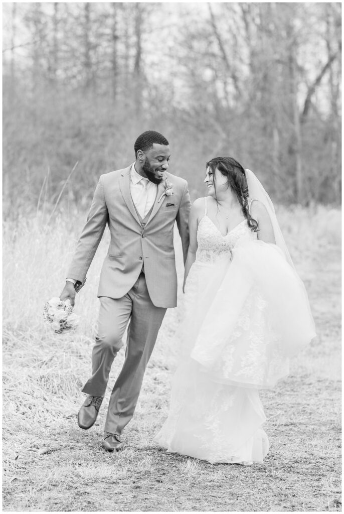 wedding couple walking hand in hand for portraits in Ohio