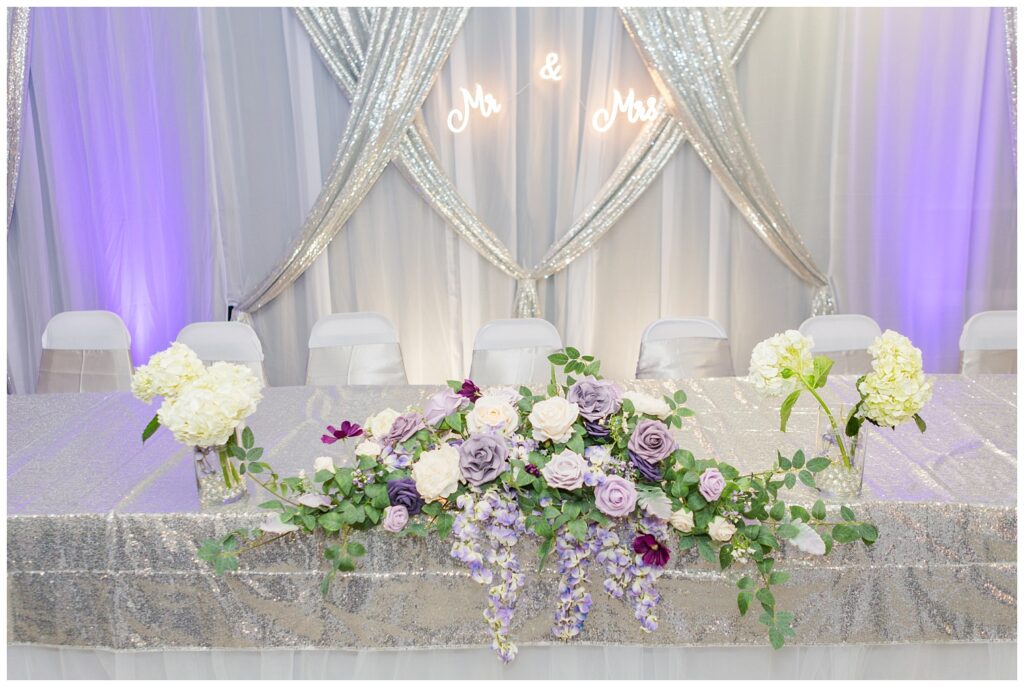 decorated table with purple and ivory flowers at reception venue in Ohio