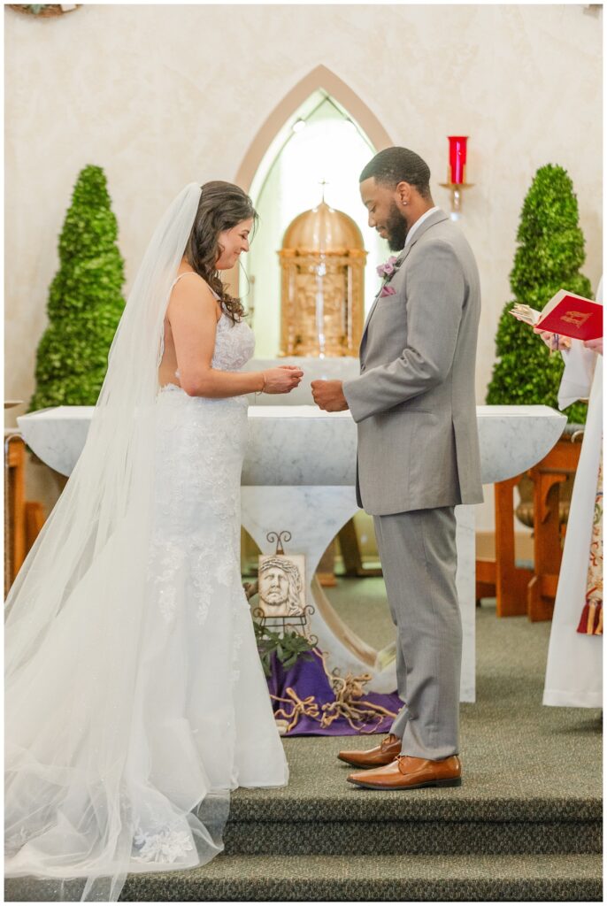 couple exchanging rings at the altar of Catholic church in Fremont, Ohio
