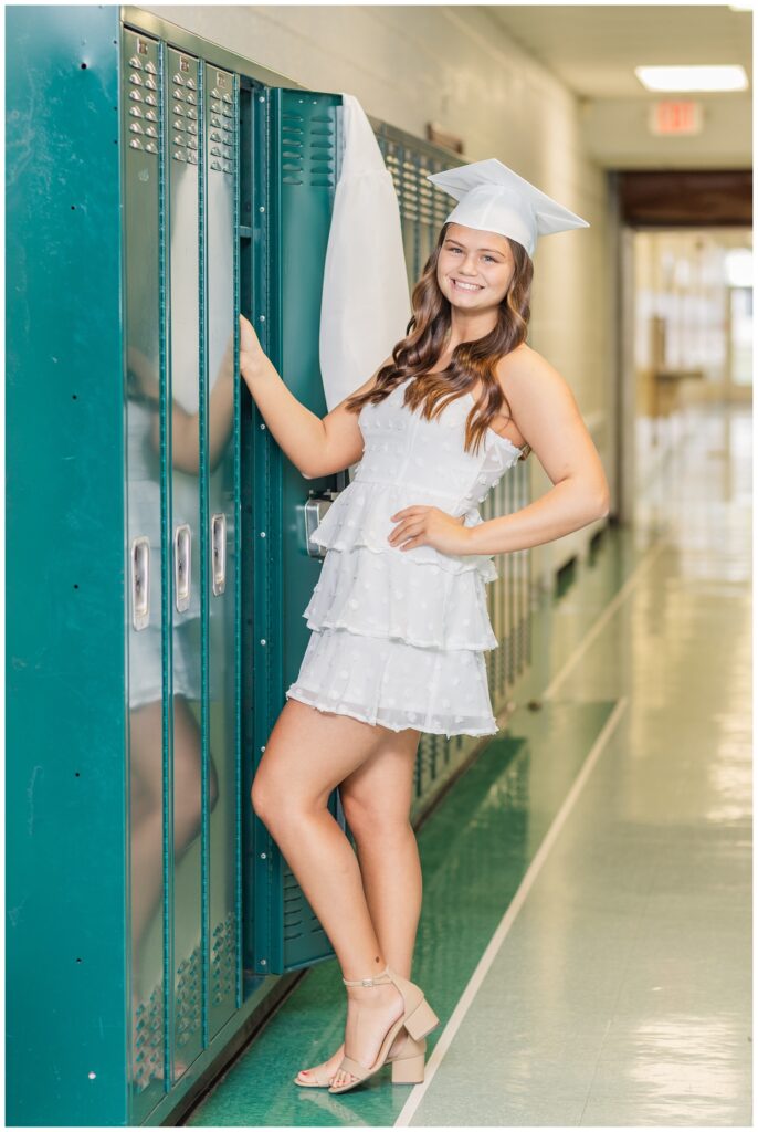 high school senior posing with her cap and gown in Castalia, Ohio