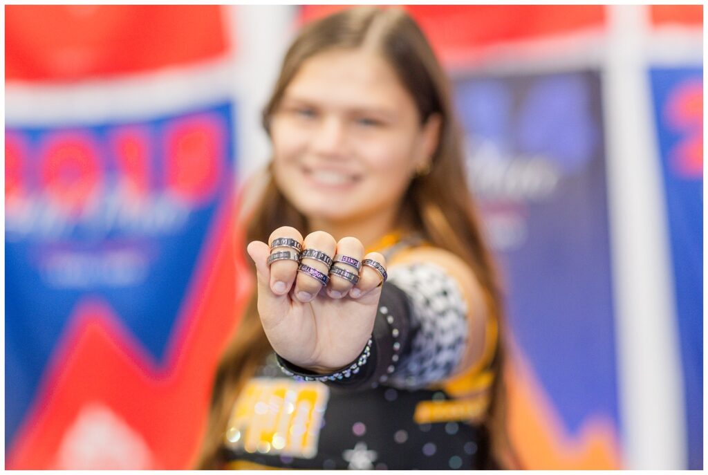 senior girl showing off her cheerleading rings at clinic in Ohio