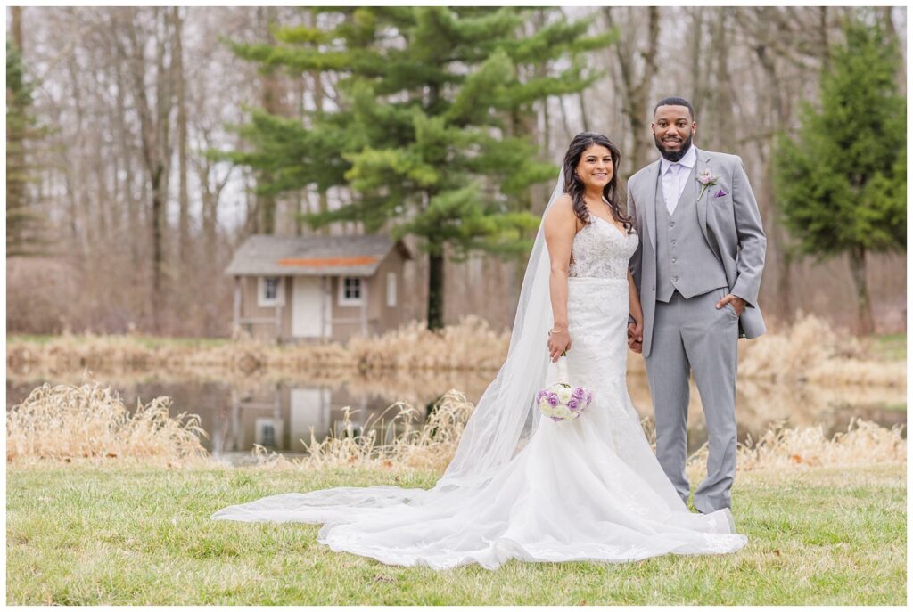 bride posing with her groom in front of a pond in Ohio