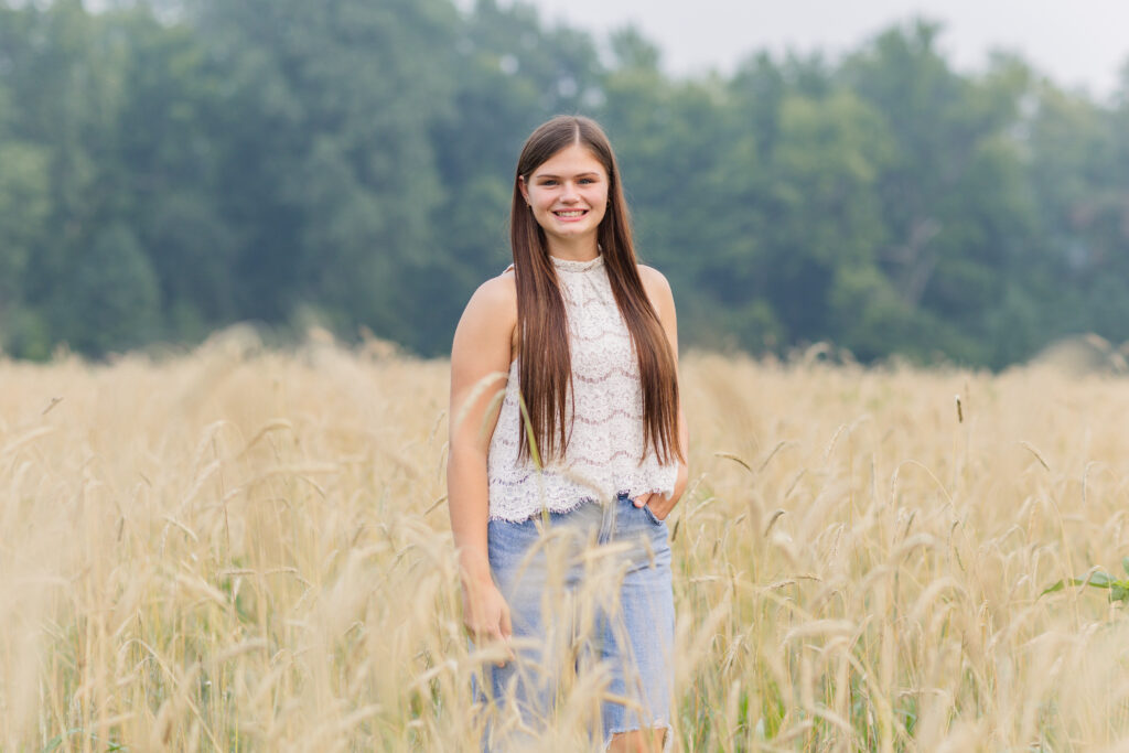 high school senior posing in a field of wheat in Sandusky
