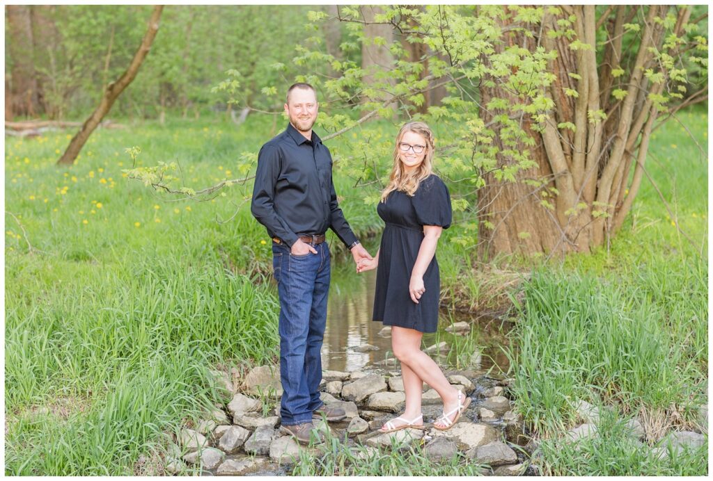 engagement couple standing on rocks at Norwalk Reservoir in Tiffin, Ohio