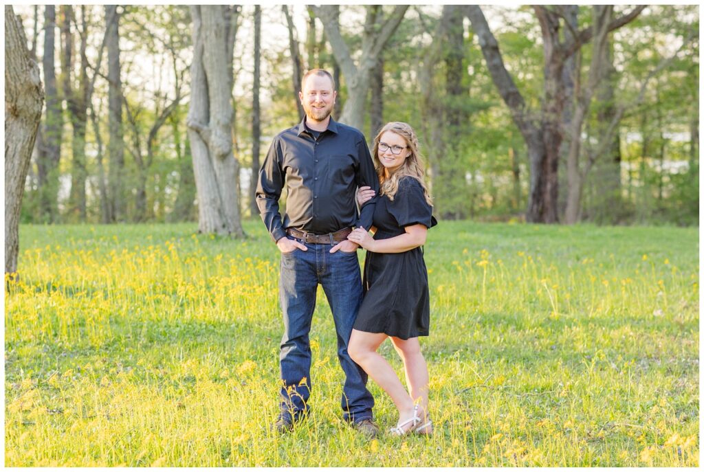 engagement couple posing in a field at Norwalk Reservoir photo shoot